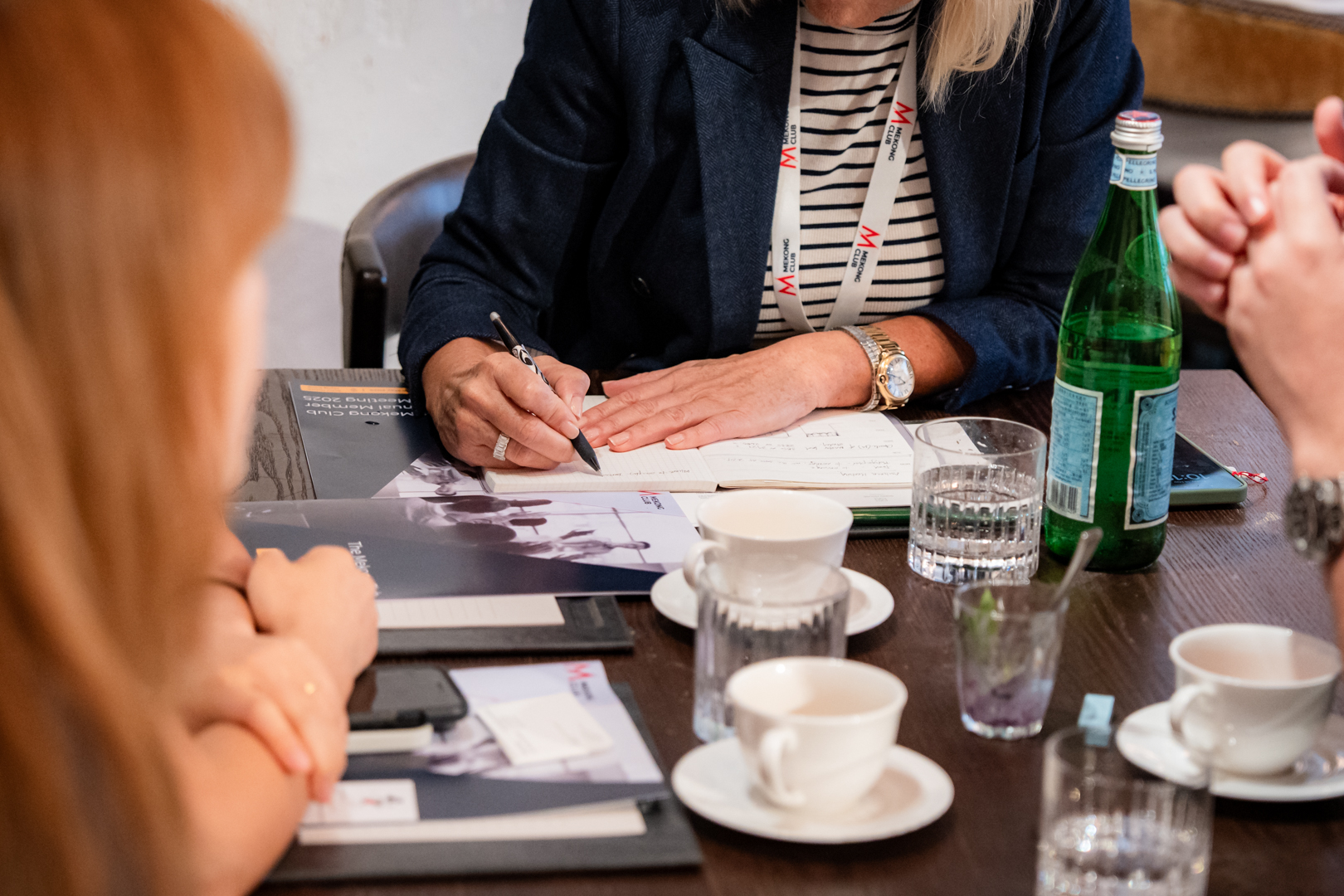 Corporate team taking notes at conference about modern slavery
