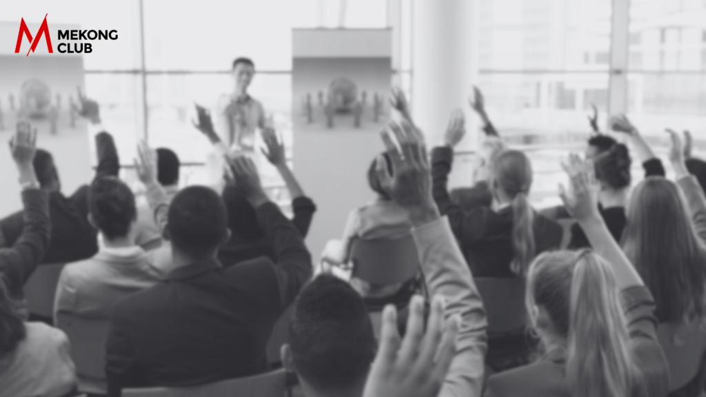 Group of members raising hands at Working Group Meeting
